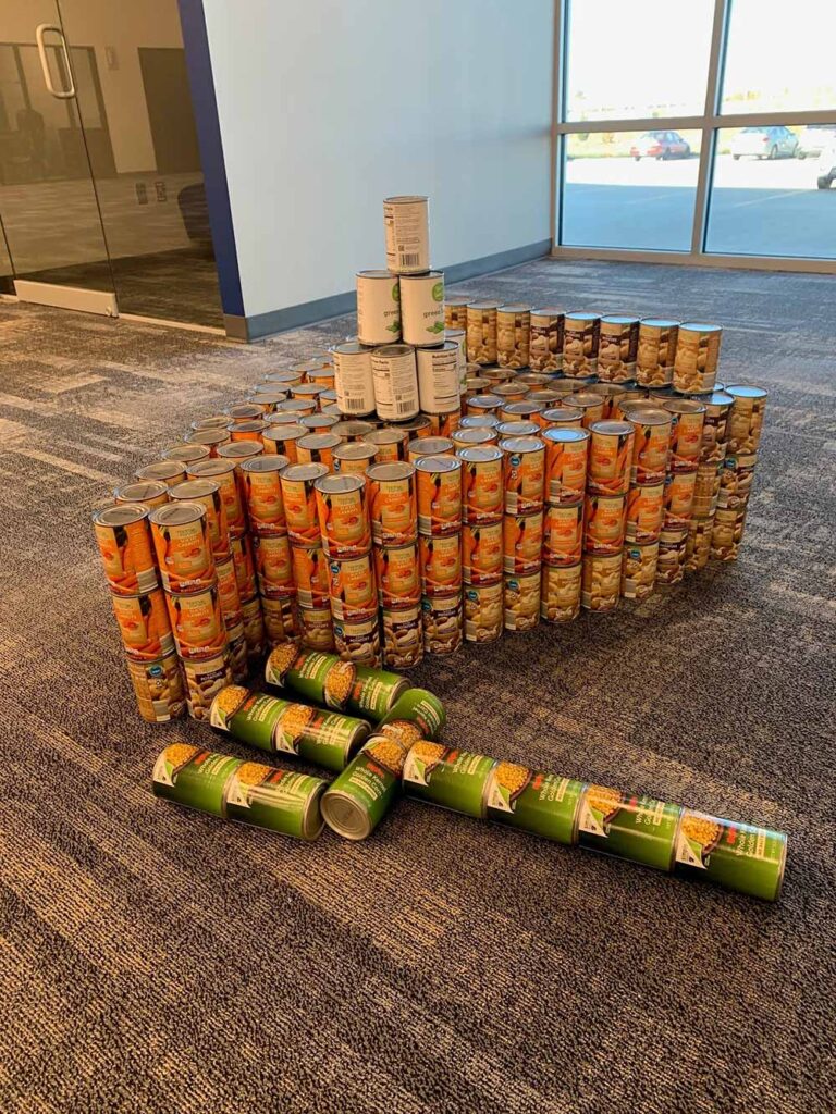 Canned pumpkin cans stacked after Basys office food drive 